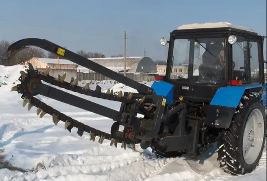 Tractor with trench digger in snow