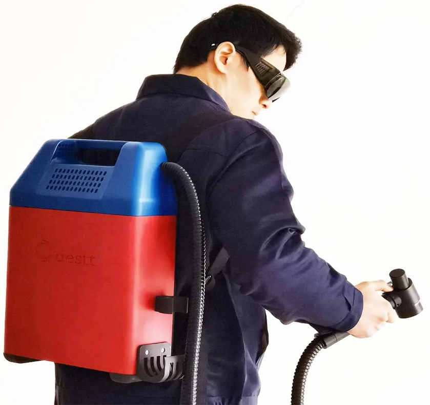 A man using laser rust cleaning machine