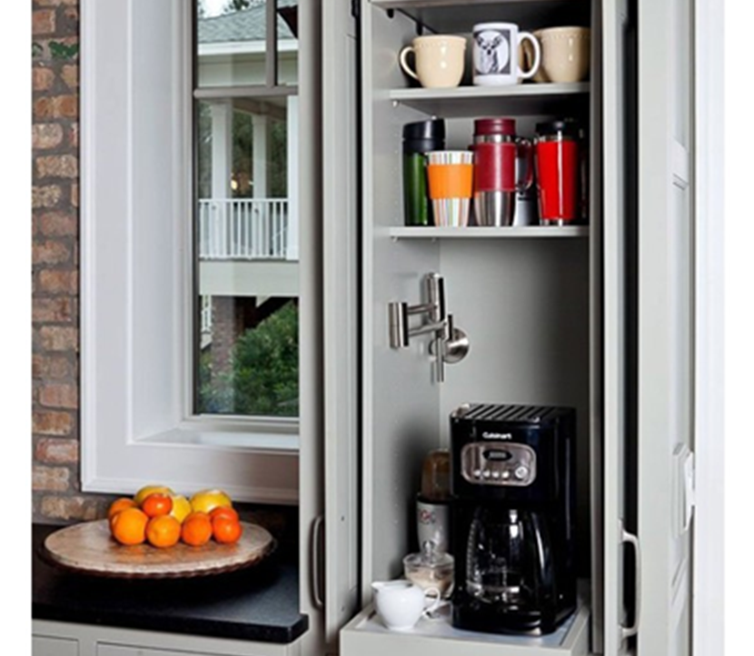 Coffee maker tucked away in cabinet